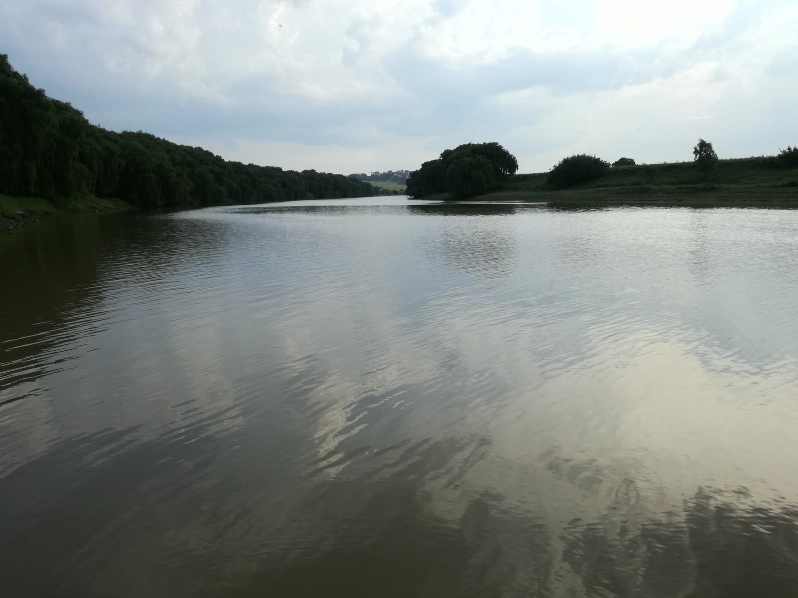 The Wilge River flowing through Frankfort, Free State, beneath a wide summer sky